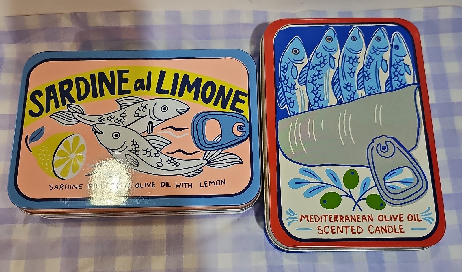 A set of sardine candles in metal tin