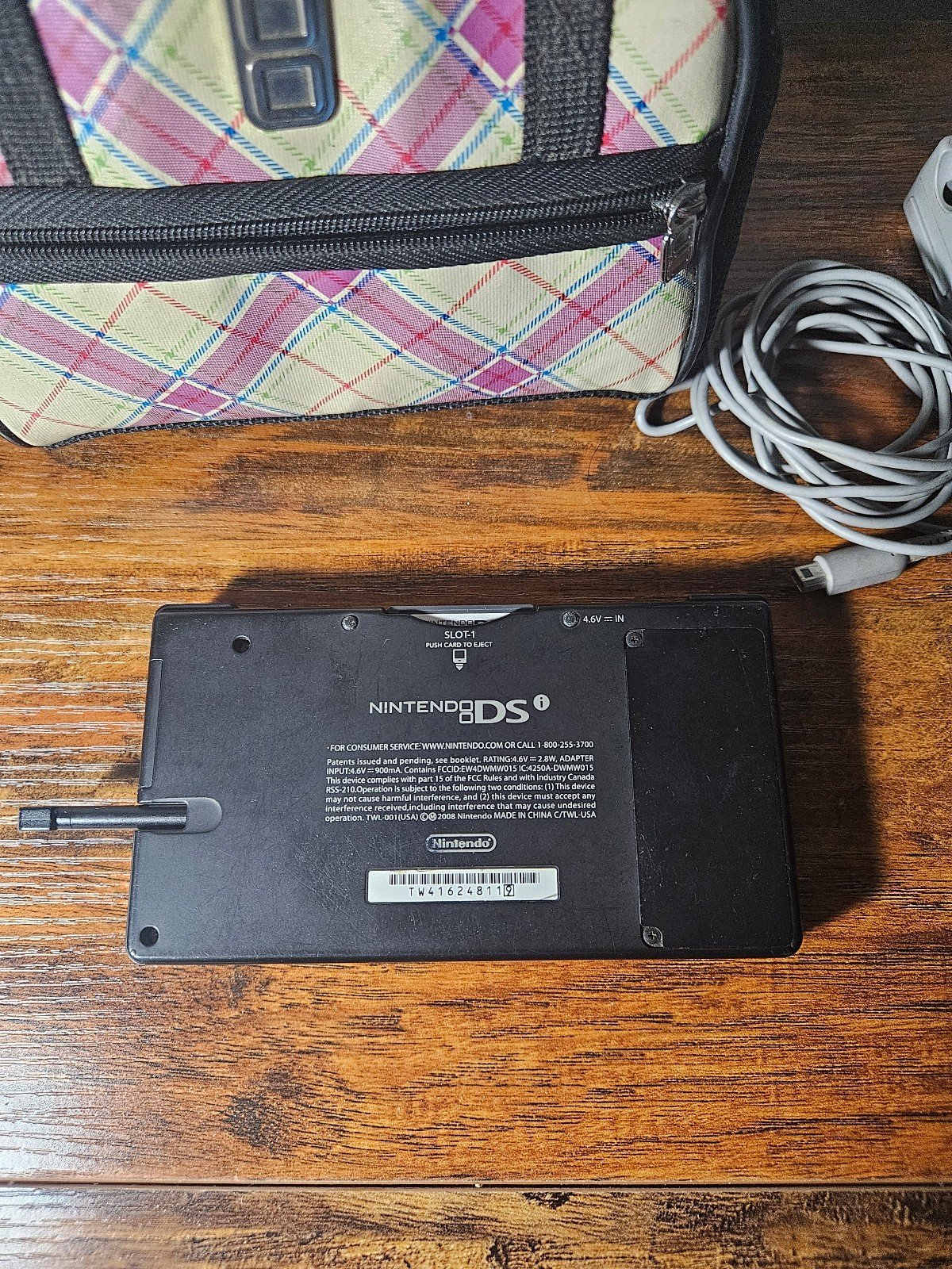 Nintendo DSi Black with original charger, pen, mario game, and pink bag