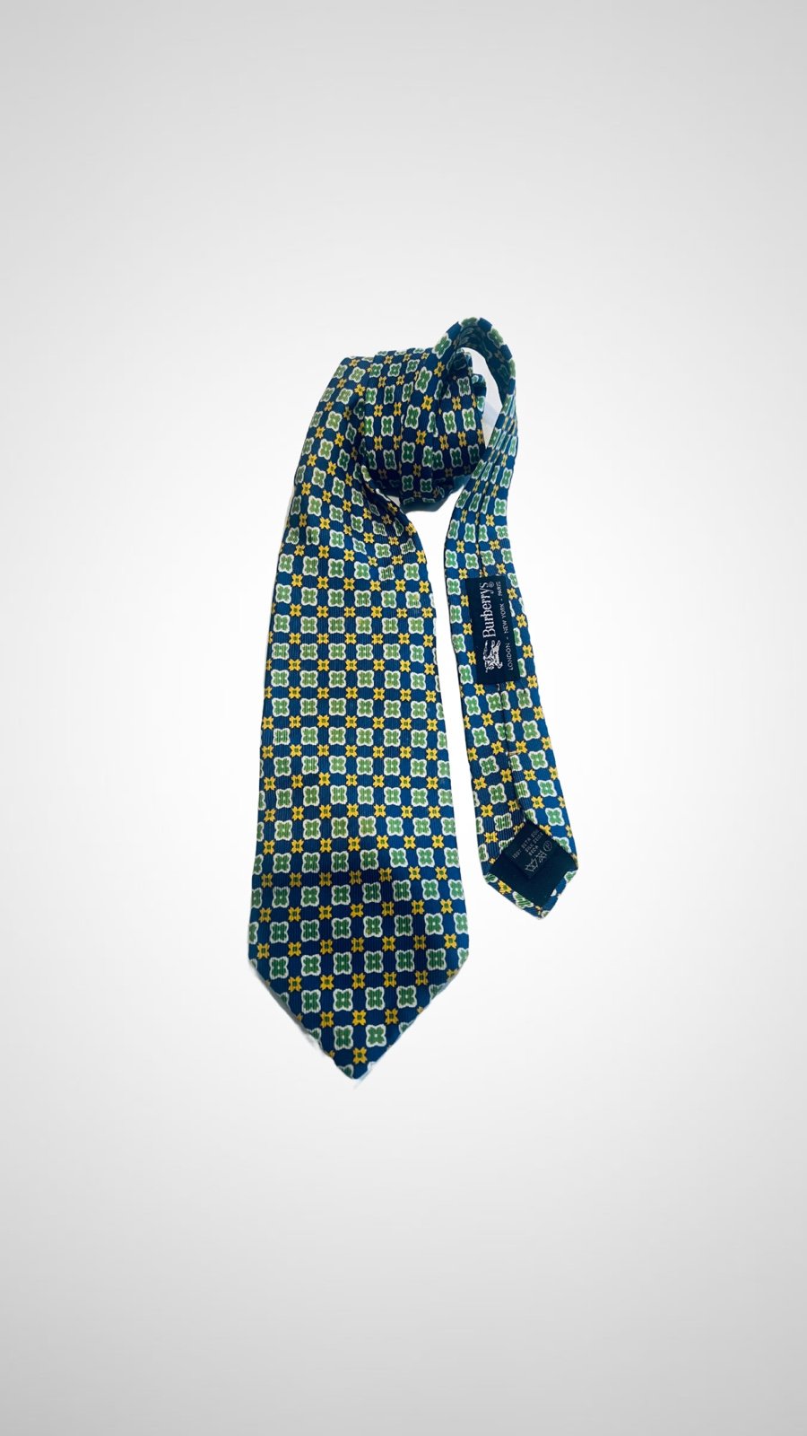 Burberry classic vintage tie in Italian-woven silk patterned w/floral designs.