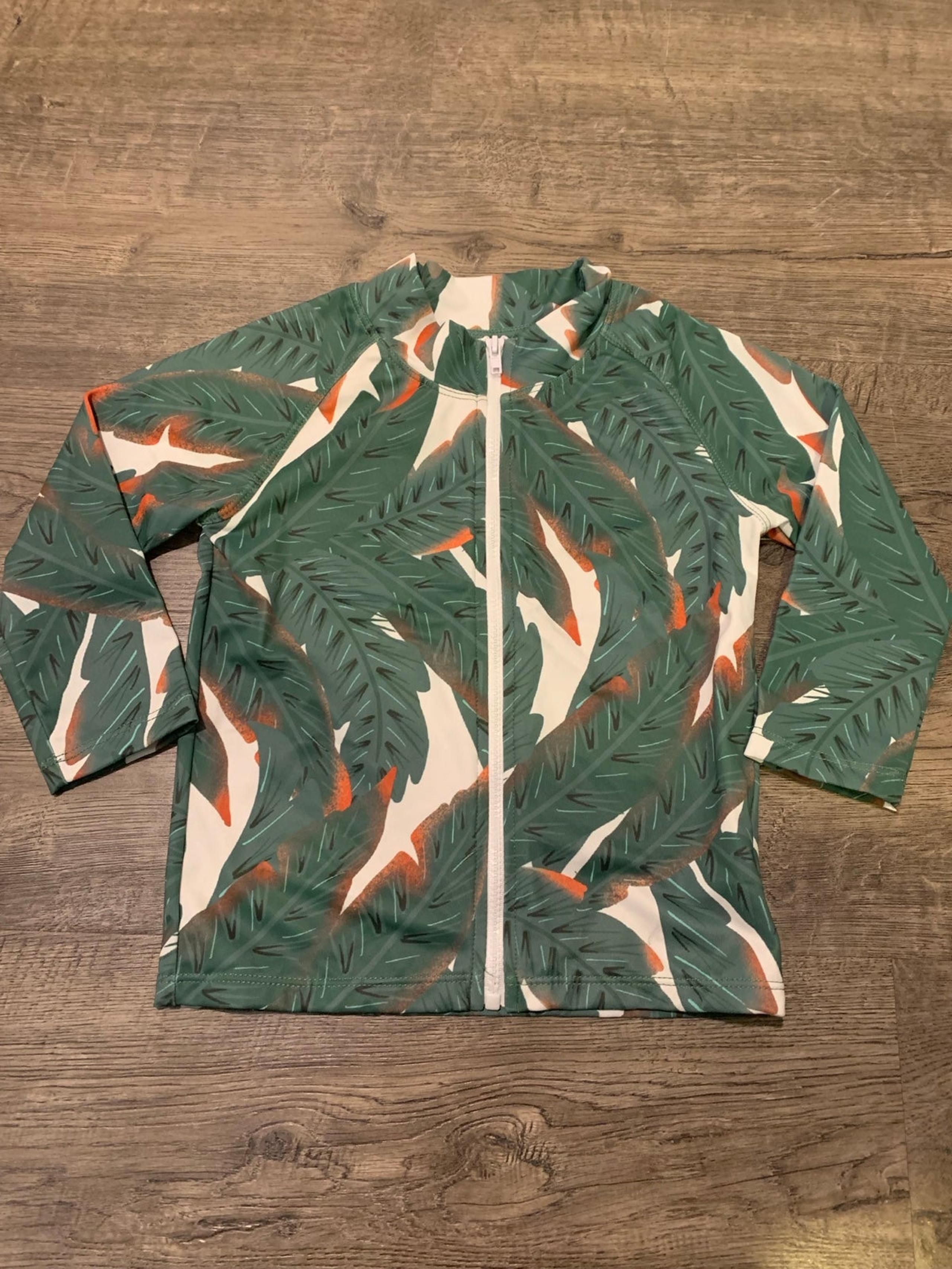 Green palm rash guard top