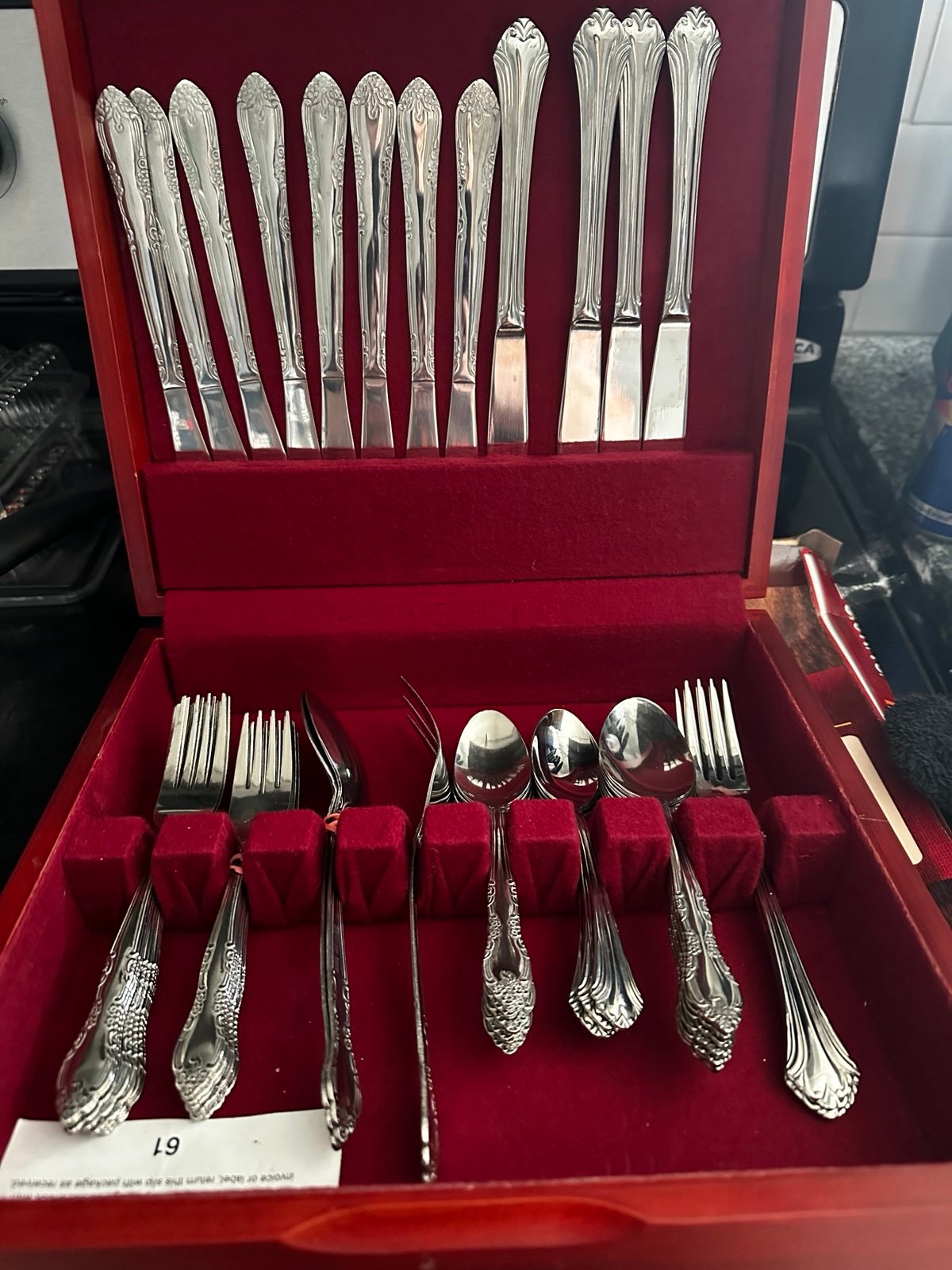 Vintage stainless silverware in a red wooden box.