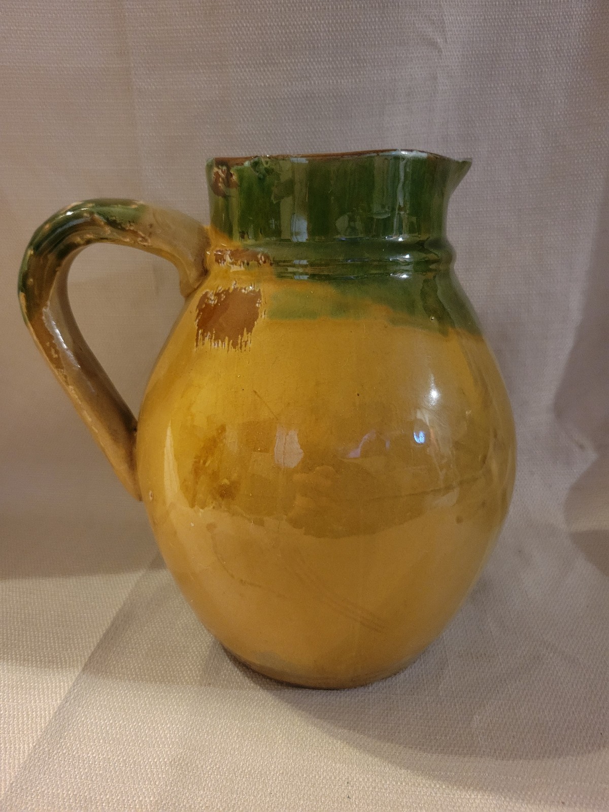 Unmarked Glazed Yellow Green Distressed Pottery Pitcher