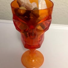 Skull plastic cup filled with crystals