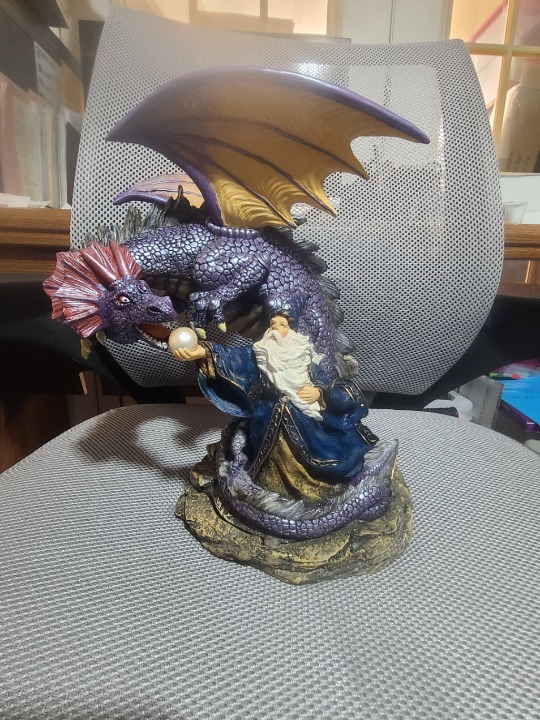 Dragon with wongs next to a Wizard Cone Incense burner
