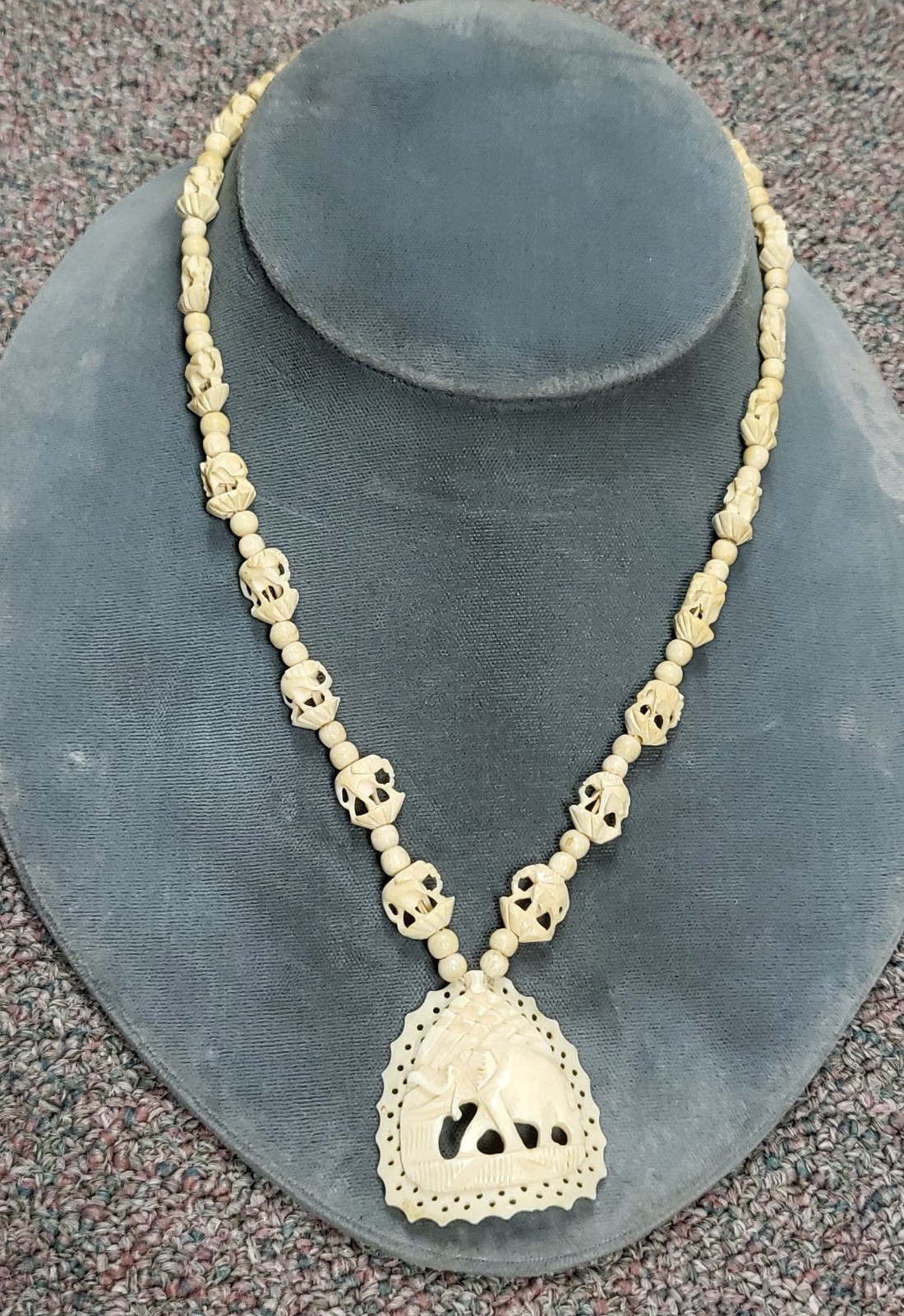 Hand carved elephant design bone necklace