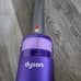 Dyson handheld vacuum with lighted crevice tool and 2-in-1 upholstery brush
