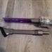 Dyson handheld vacuum with lighted crevice tool and 2-in-1 upholstery brush