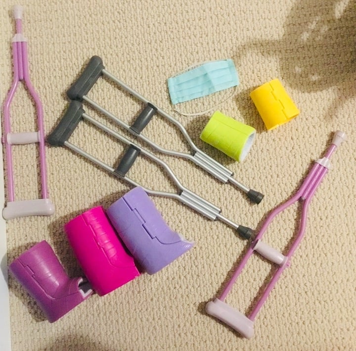 American Girl doll wheelchair, cast, crutches, and hospital clothes.
