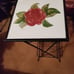 2 iron plant tables with a tile top with a rose flower picture made by xj