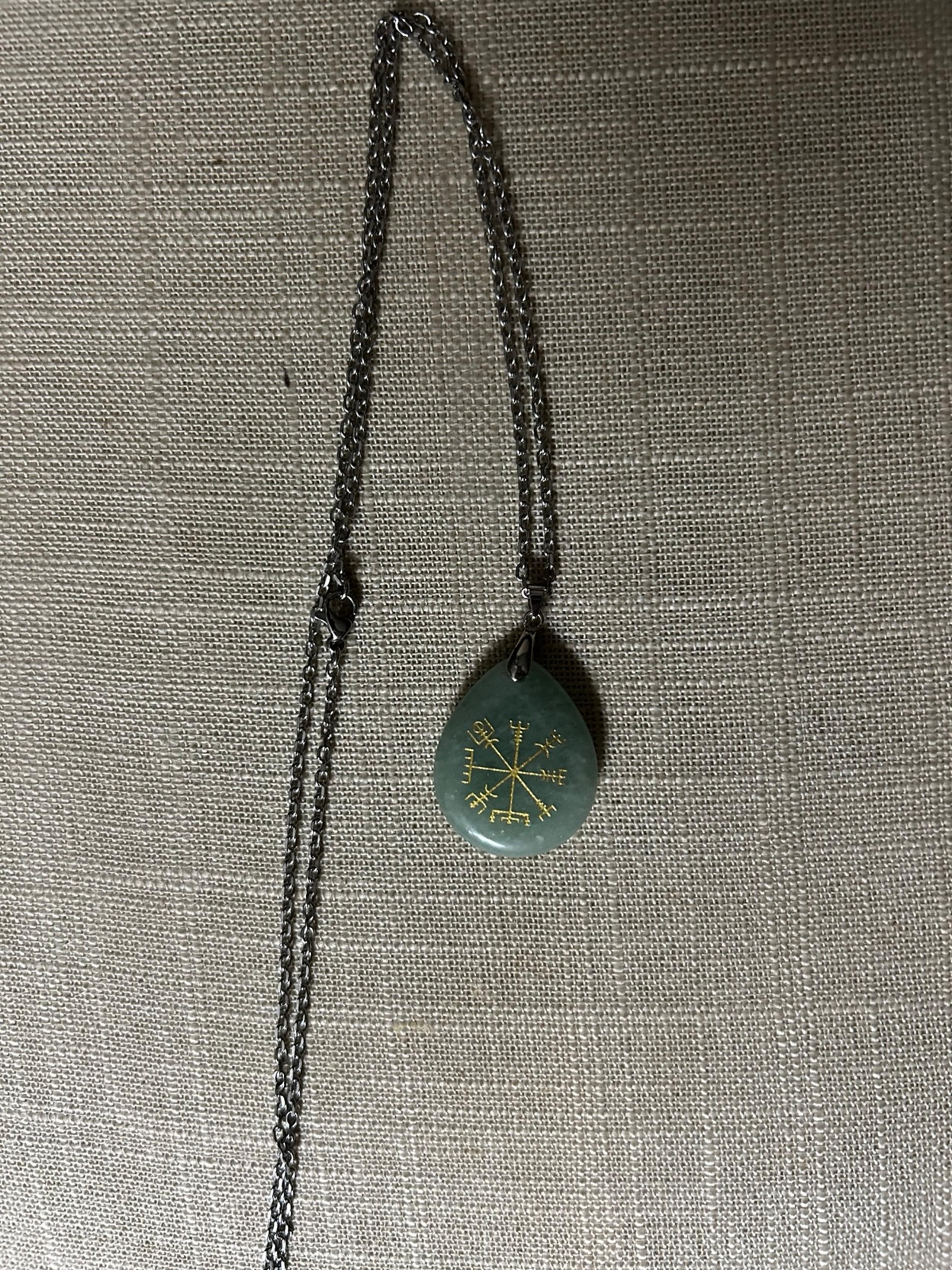 A jade teardrop pendant on a sterling chain