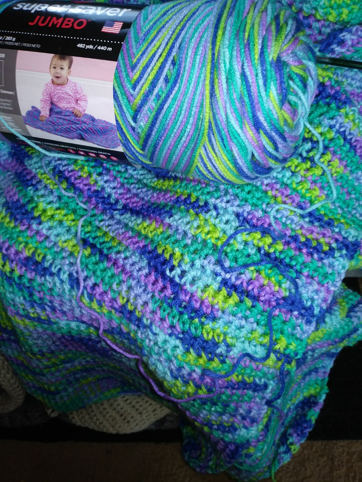 A multi color handmade crochet throw