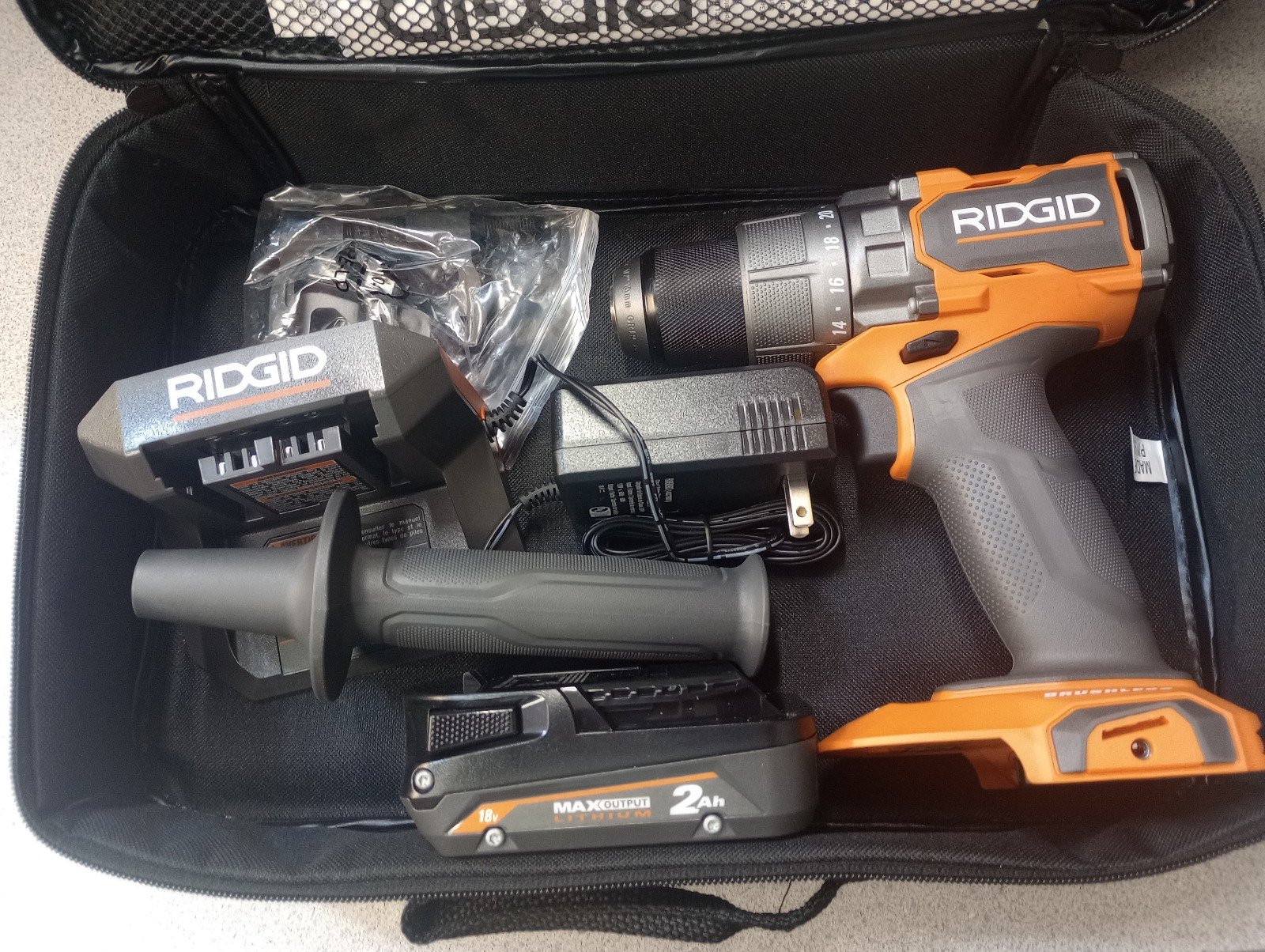 Brand new Ridgid 18 volt brushless drill with battery case and charger