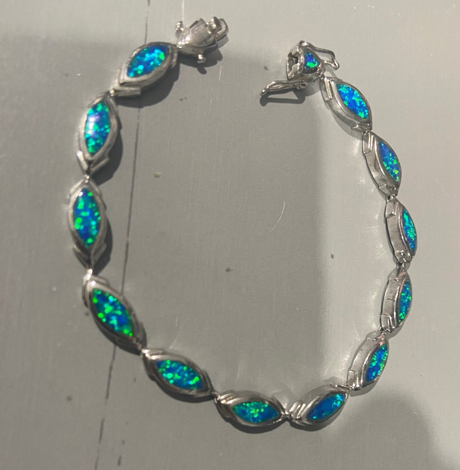 Oval blue fire Opal inlay sterling silver bracelet .