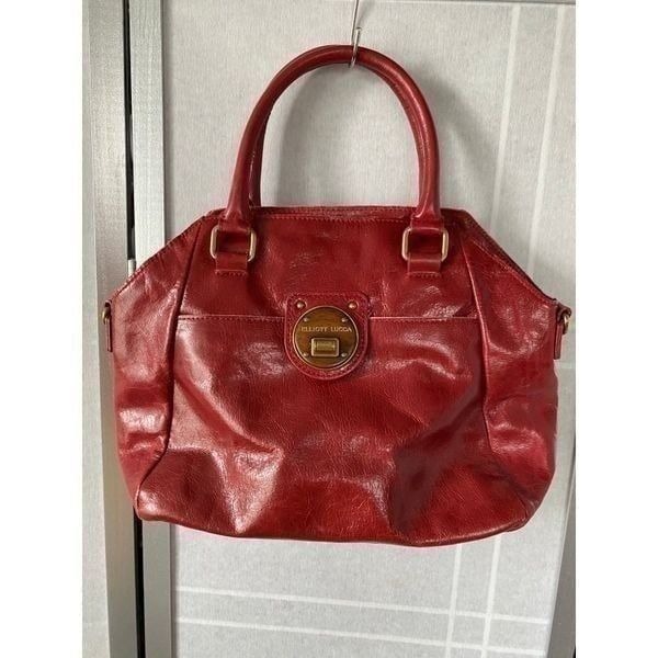 Elliott Lucca red purse, in excellent like new condition shoulder strap was miss