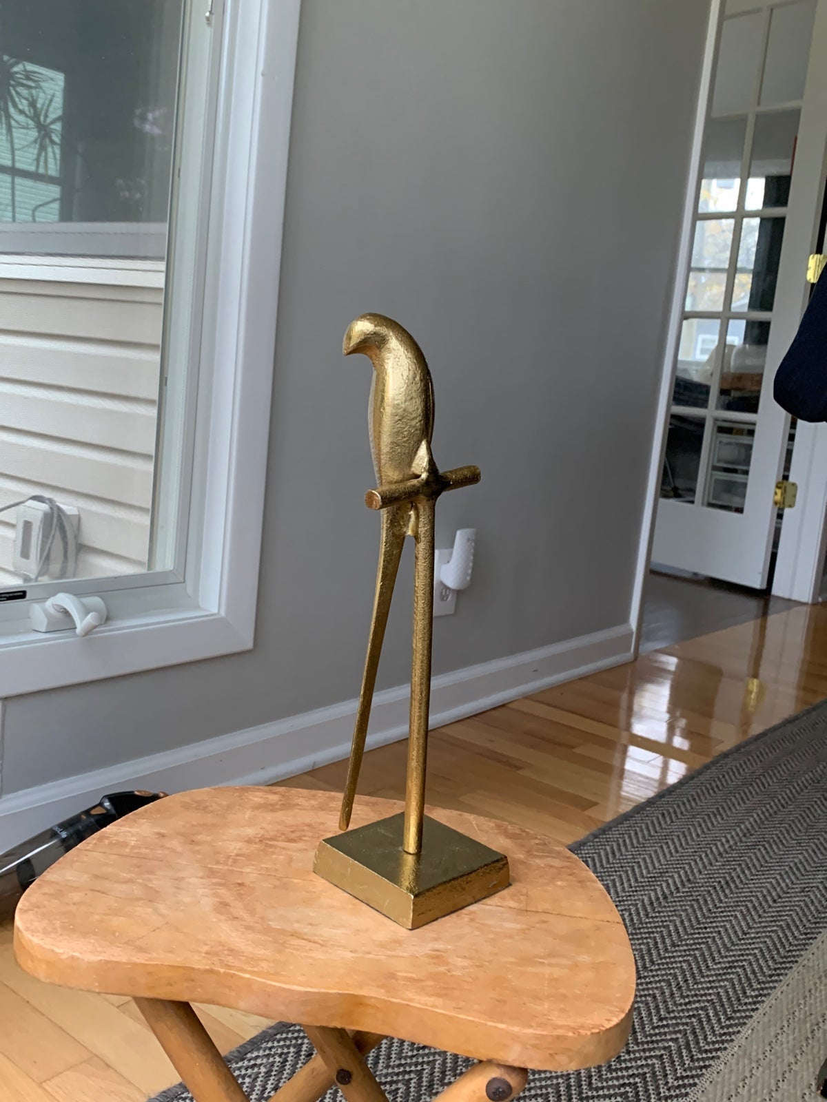 MCM metallic bird perched on stand