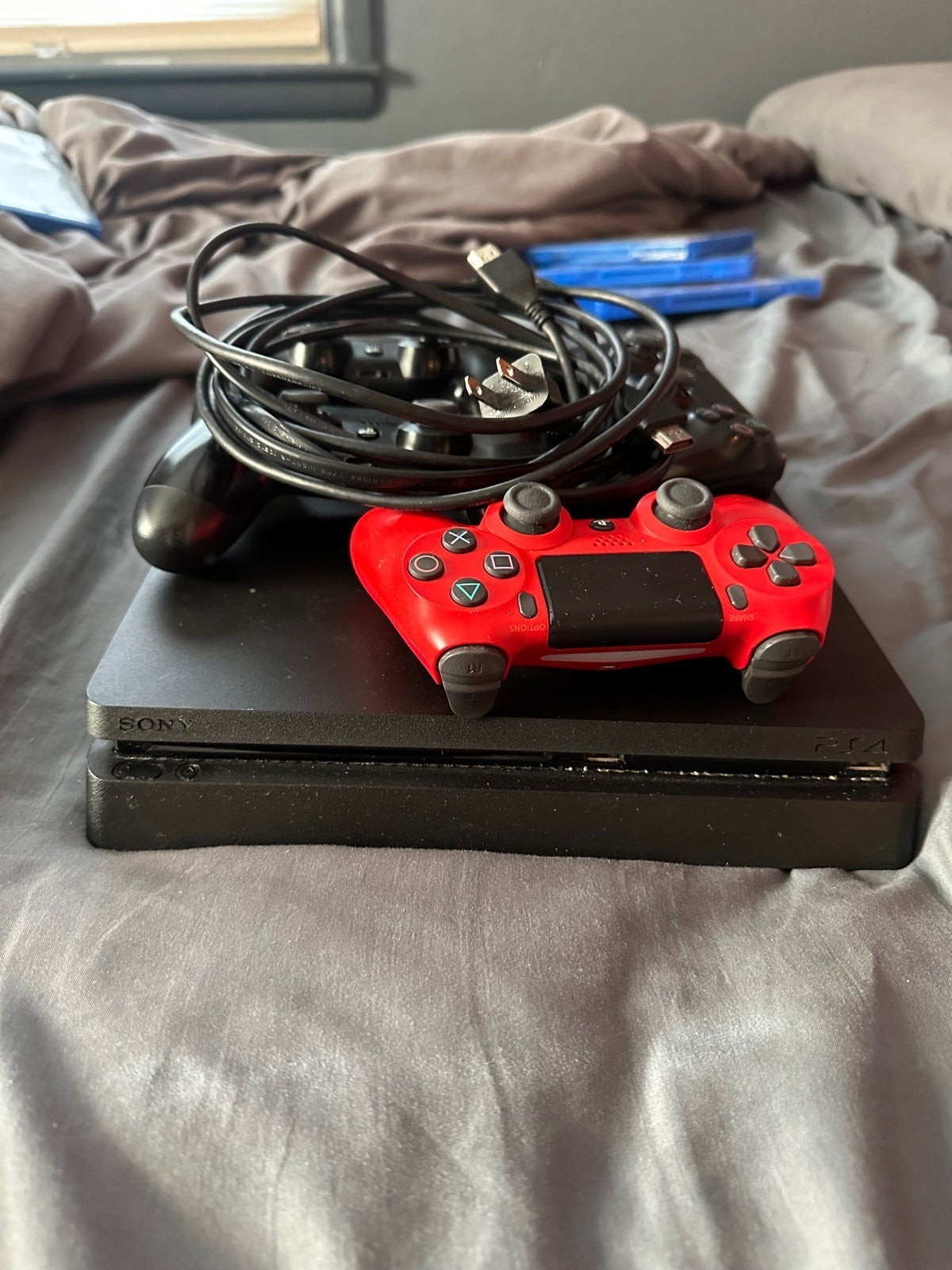 PlayStation 4 console with cords and 4 controllers. Games included in pictures