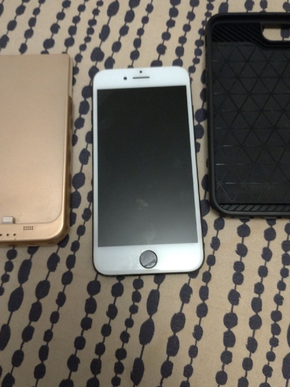 iPhone 7 with battery pack case and wall