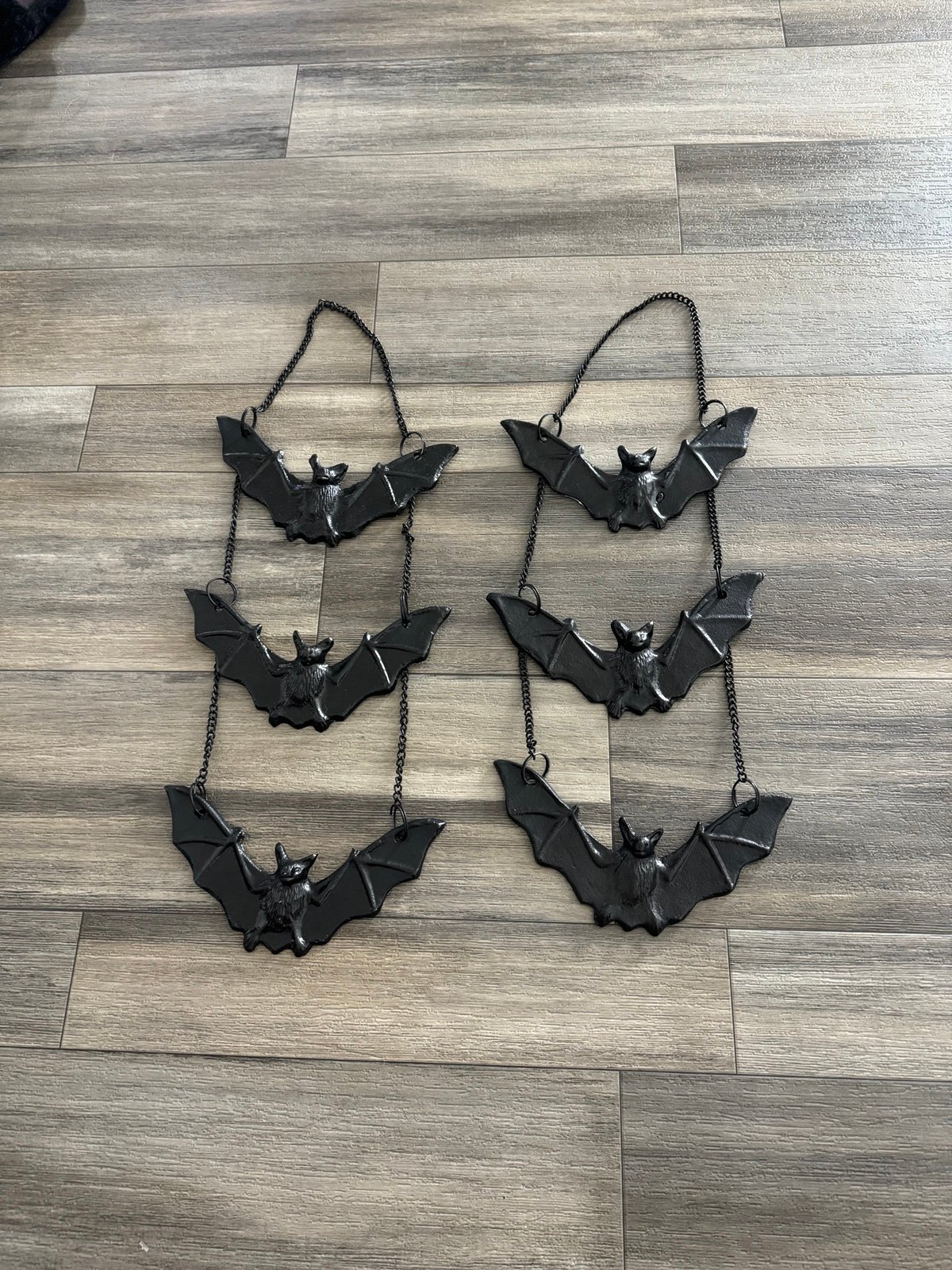 2 metal hanging bats with chains