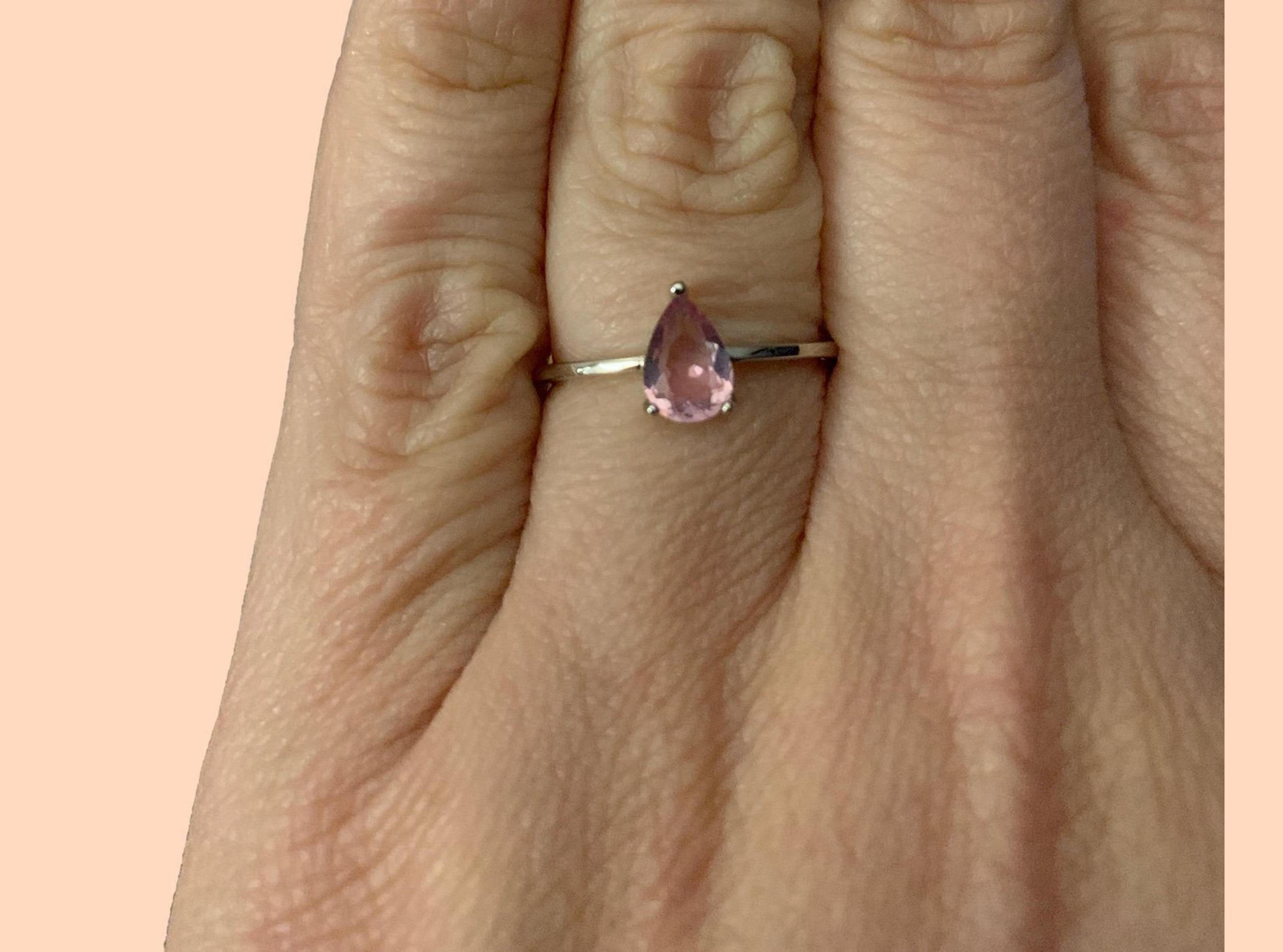 Elegant sterling silver ring with a pink teardrop gemstone. Perfect for any occa