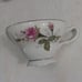 Vintage china tea cups and saucers with rose print and gold guilding.