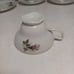 Vintage china tea cups and saucers with rose print and gold guilding.