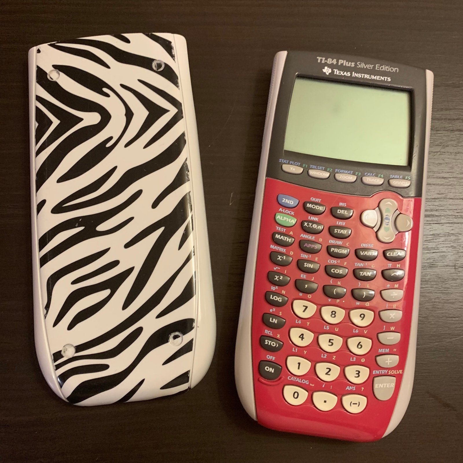 Texas Instruments TI-84 silver edition calculator with zebra case
