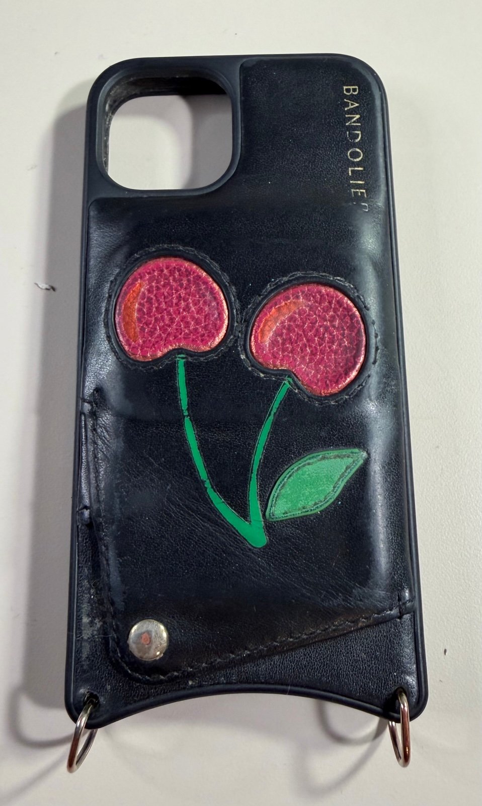 iPhone 14 Bandolier Blk Leather case with cherry's. Has one pocket of cards.