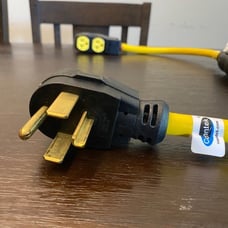 Two power cords extend the higher dryer voltage to a three-cord plug.