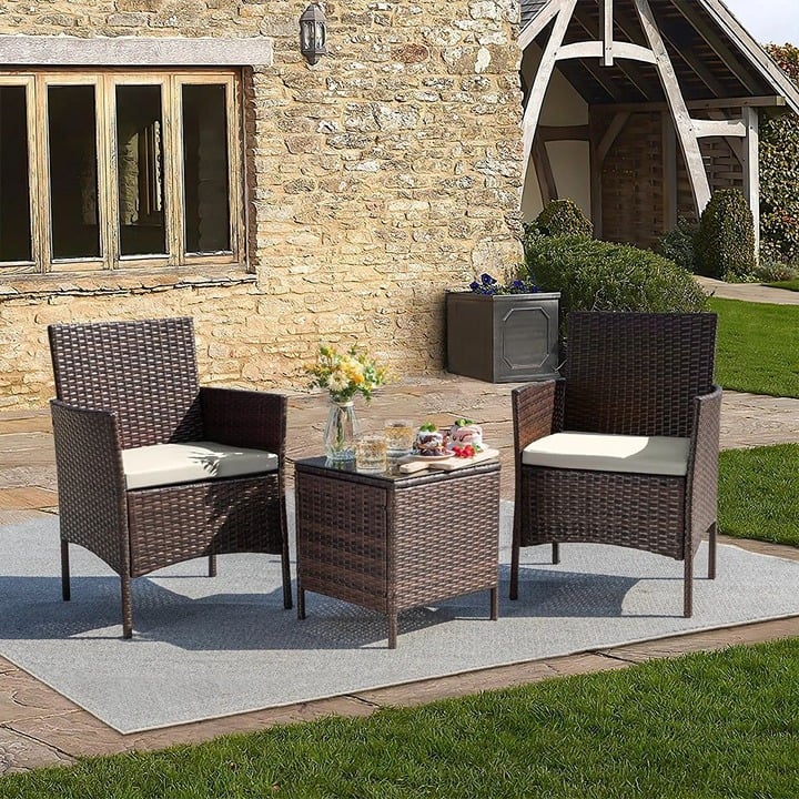 Brown Patio Table and Chairs Set with Tan Cushions