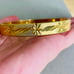 Vintage Gold Tone Etched Hinged Bangle Bracelet with Safety Chain