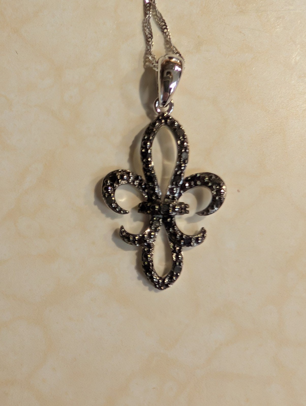 1/4 ct tw black diamond Fleur de lis necklace on an 18inch 10k white gold chain
