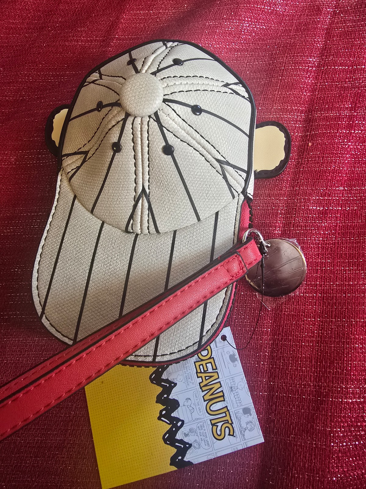 This is a Peanuts Charlie Brown Good Grief baseball cap coin purse.