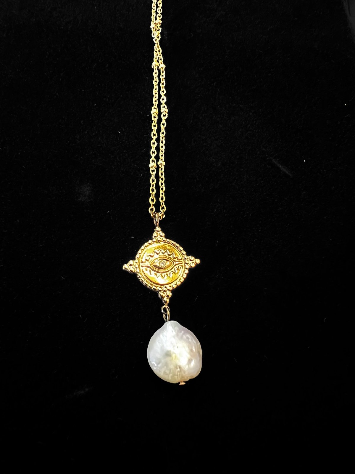 Eye with pearl necklace