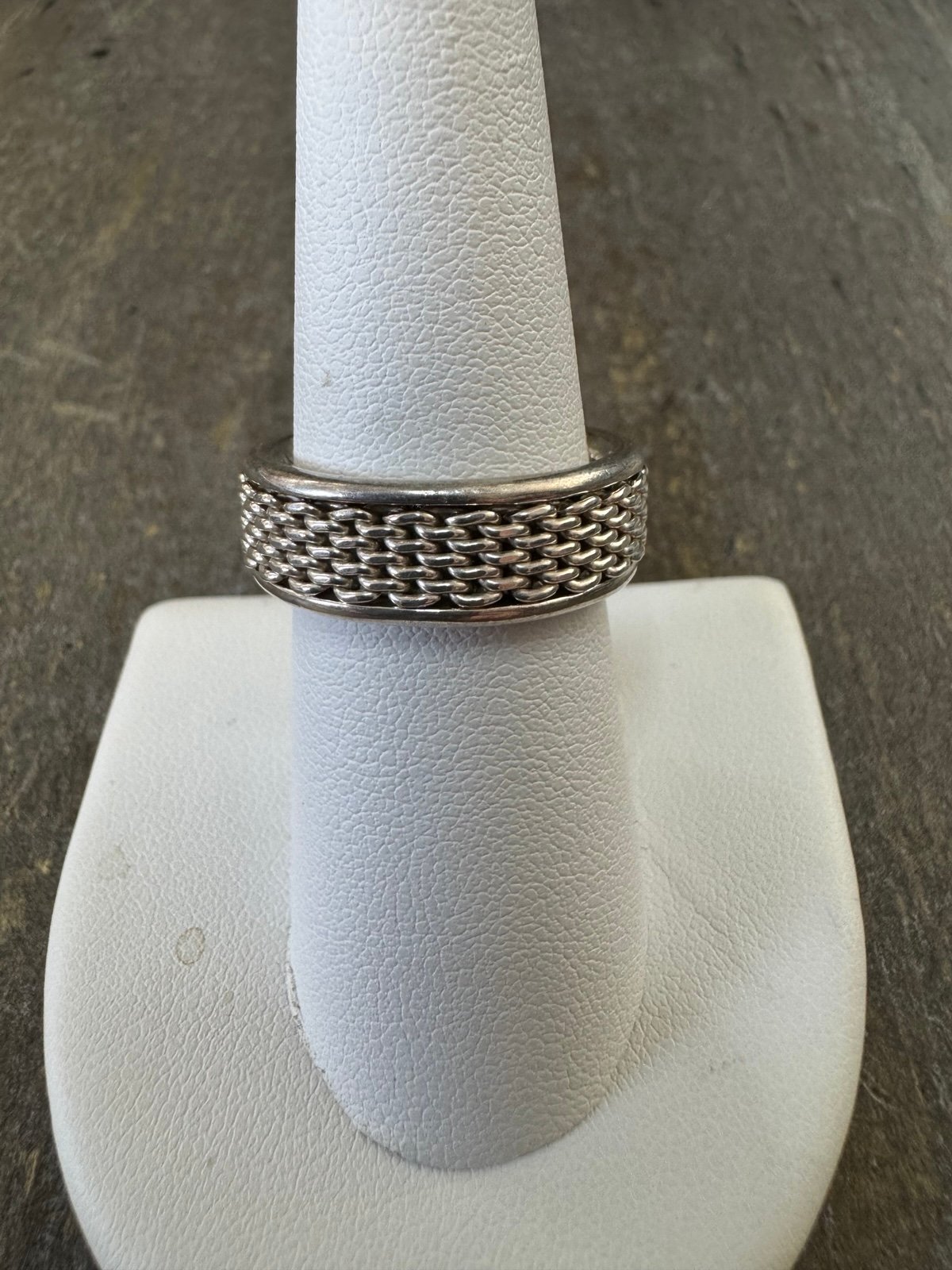 This is a sterling silver mesh band ring made by Joseph Esposito. The ring is si