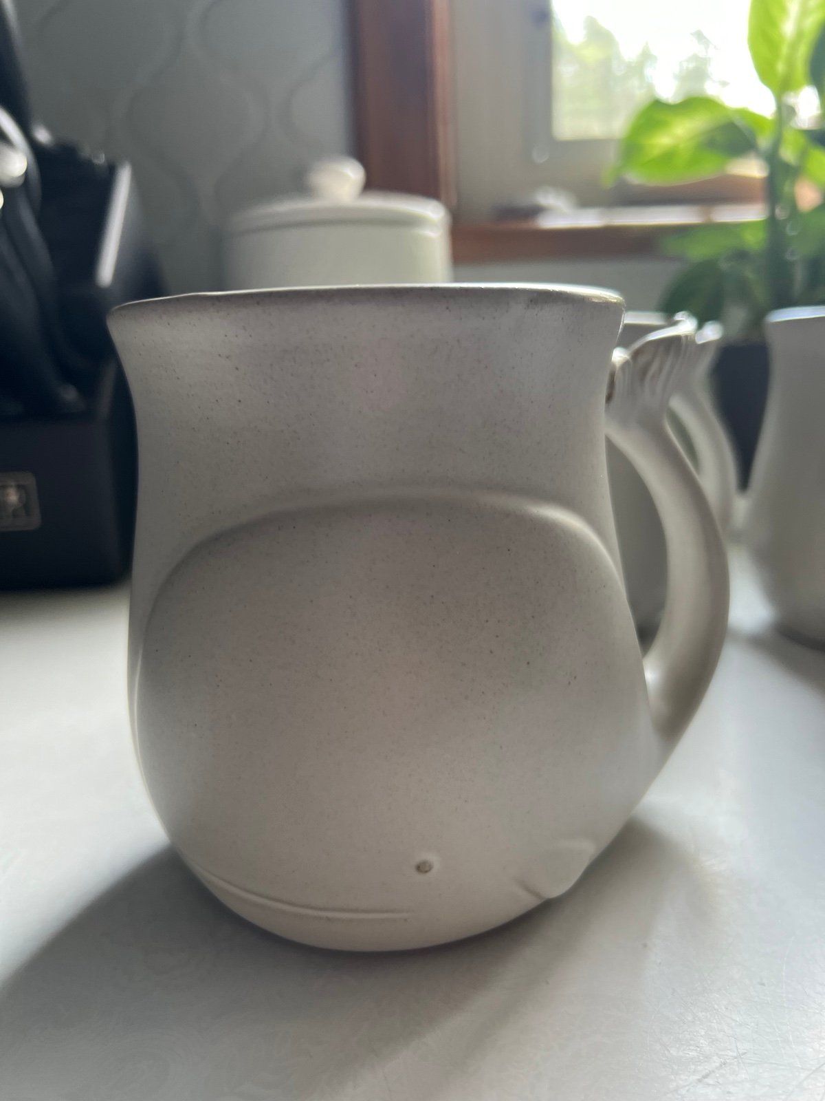 Four ceramic whale mugs