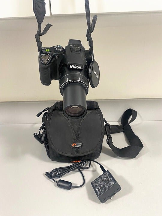 This Nikon Coolpix P500 camera and is graded . tripod is not include