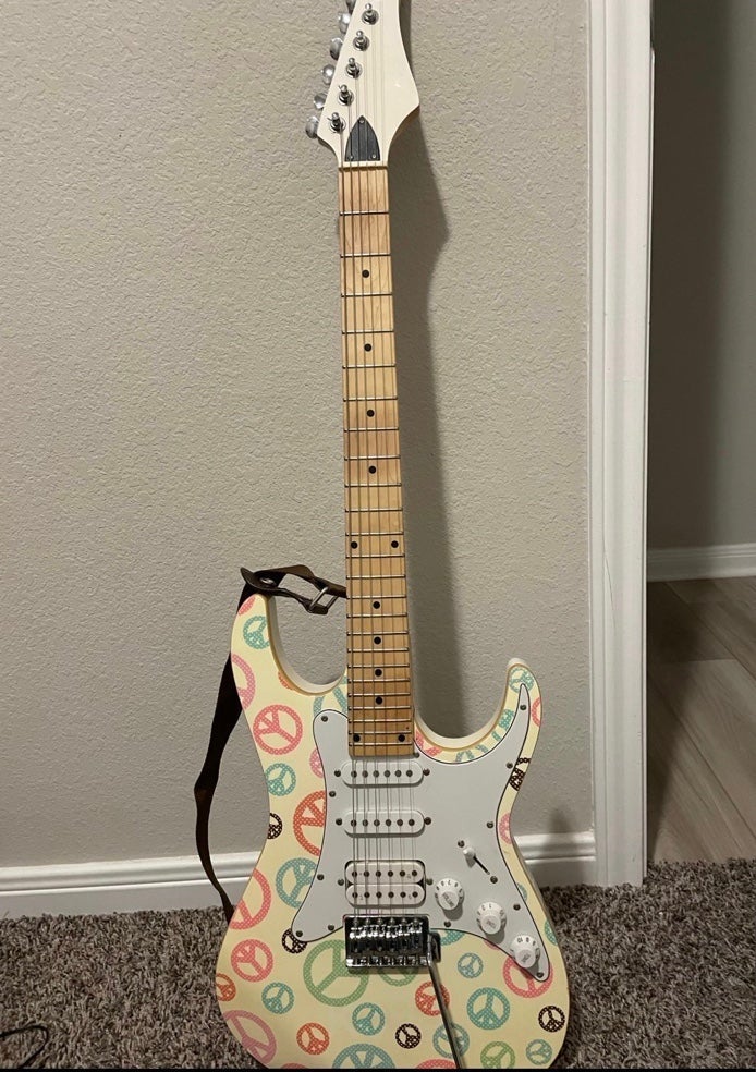 Guitar with peace signs on it