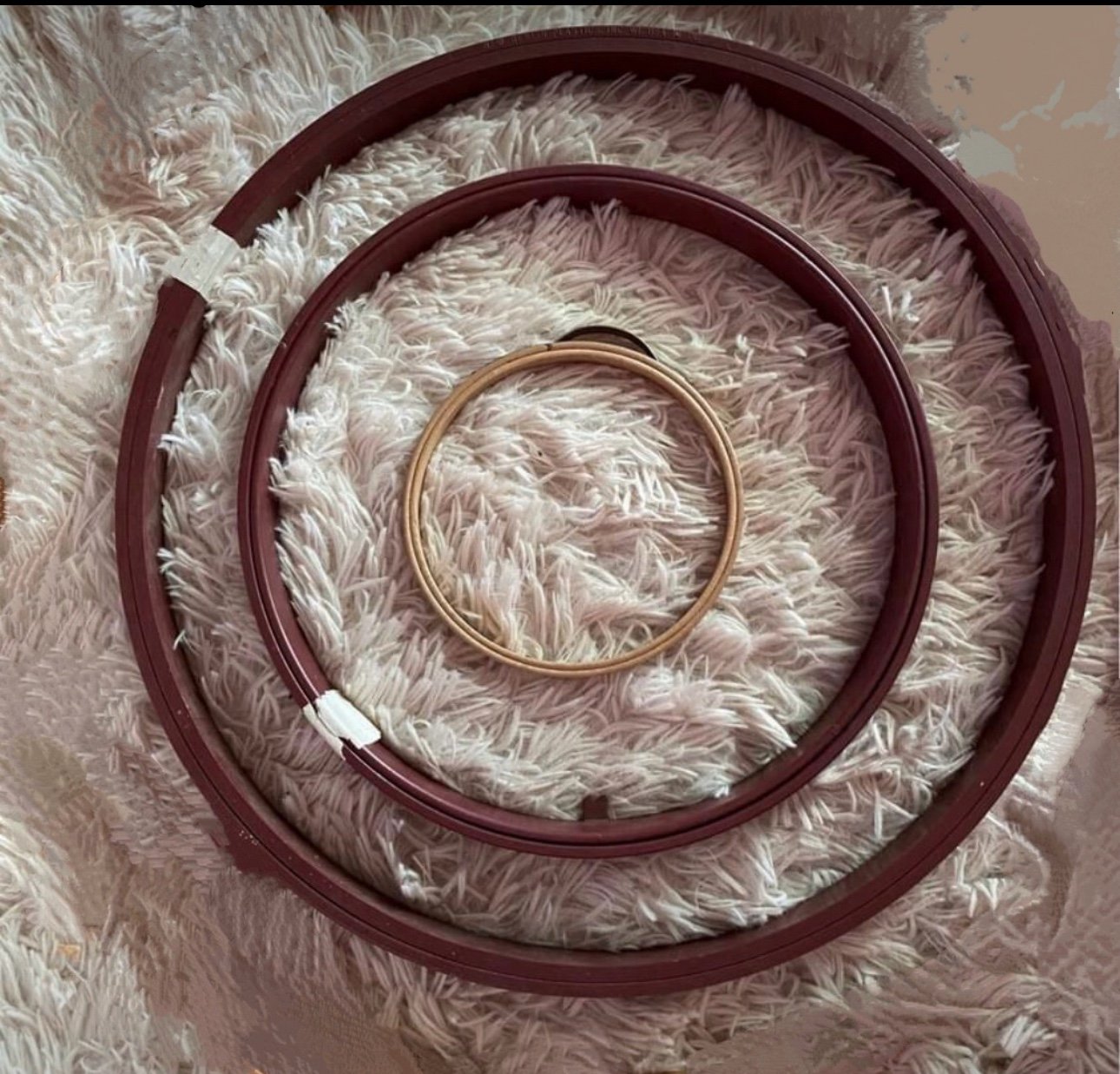 Three round quilting hoops.