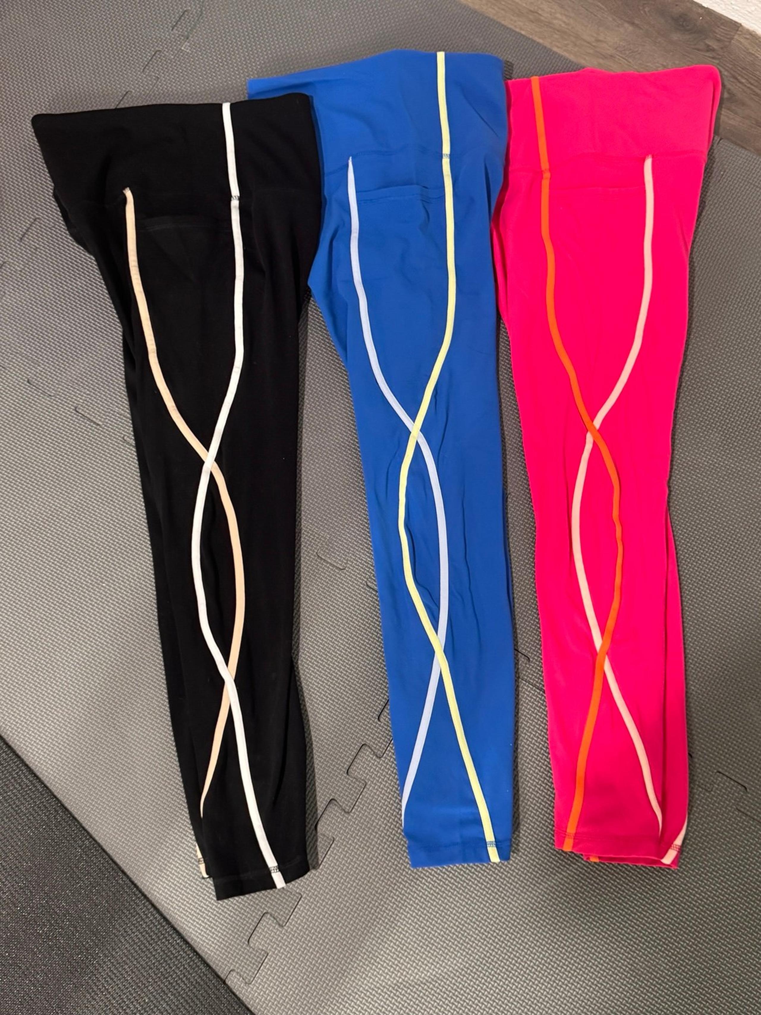 3 pairs of leggings. black, blue, pink with pockets & wavy accent. Size medium