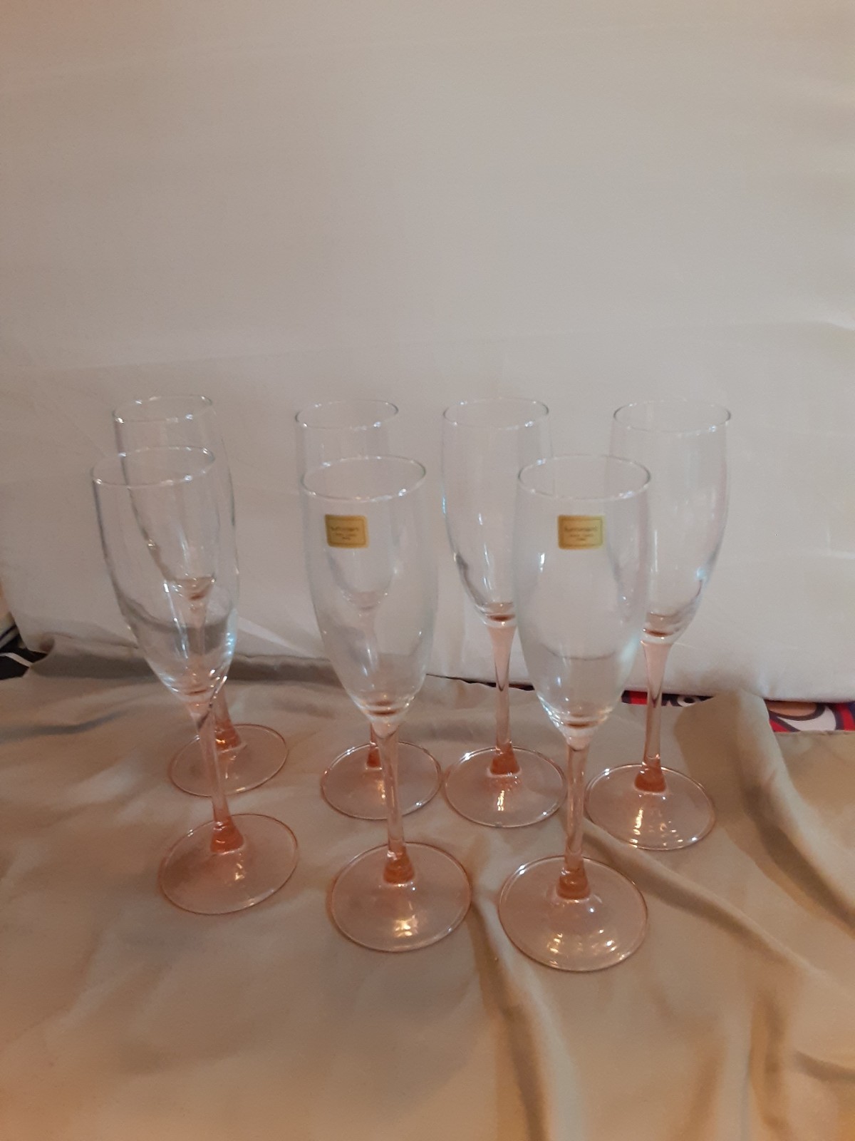 Seven Luminarc flutes with pink base and stem