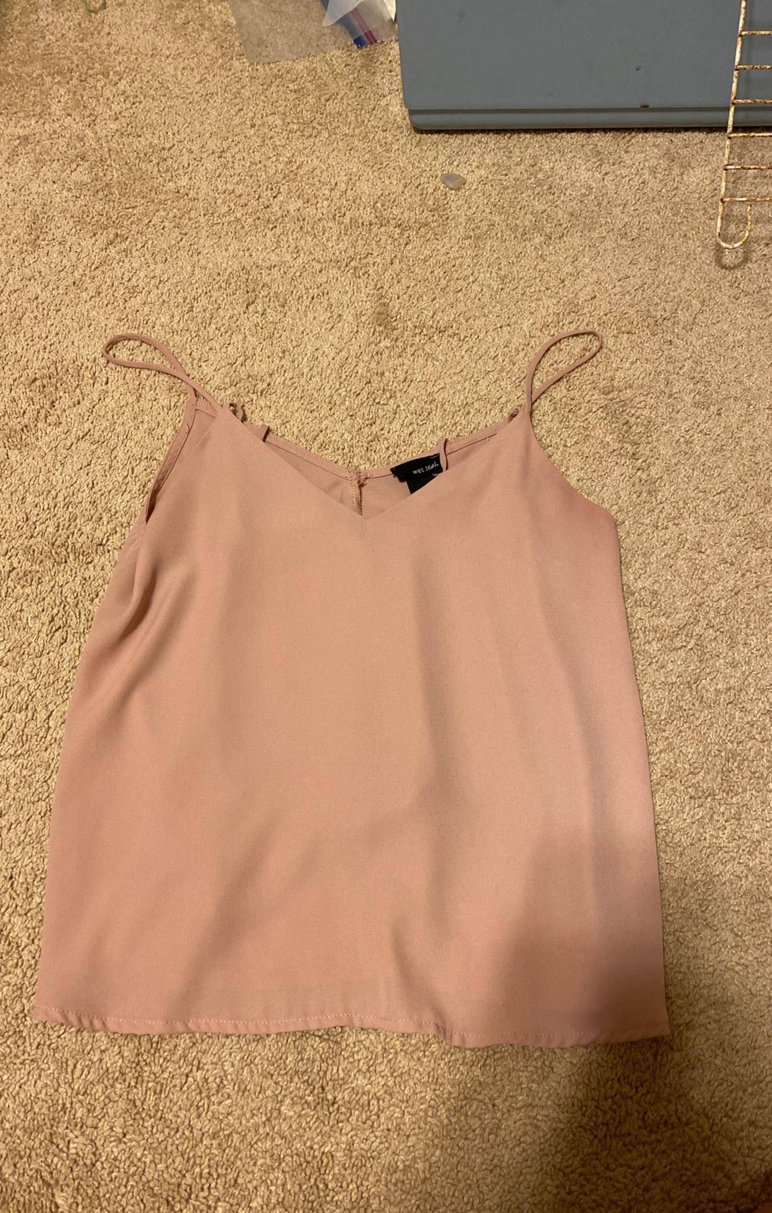 A pink tank top brand is wet seal