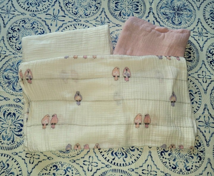 Bundle of baby things -burp cloths, waterproof pads, swaddle blankets, etc.