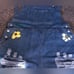 Jean overalls with pockets and hand painted daisies distressed look. Says 3x bu