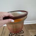 TRIO OF LARGE AMBER HURRICANE LAMPS WITH STANDS