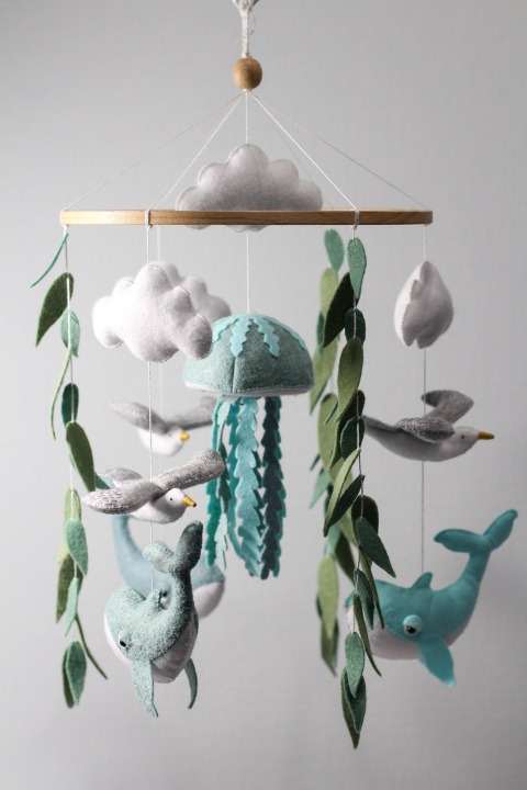 Whales, jellyfish, seagulls, algae and clouds decorate newborn nursery