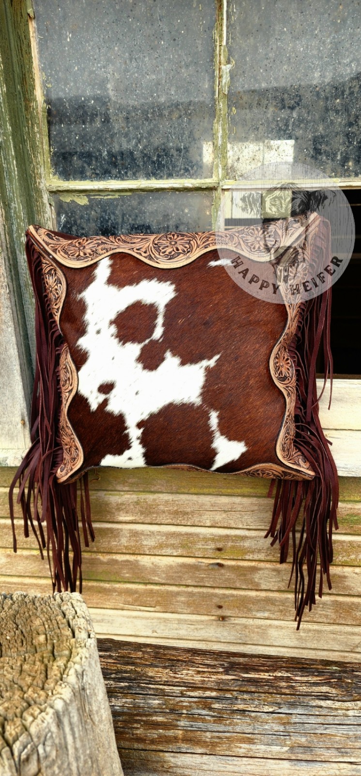 Stylish cowhide pillow with intricate leather trim. NWT