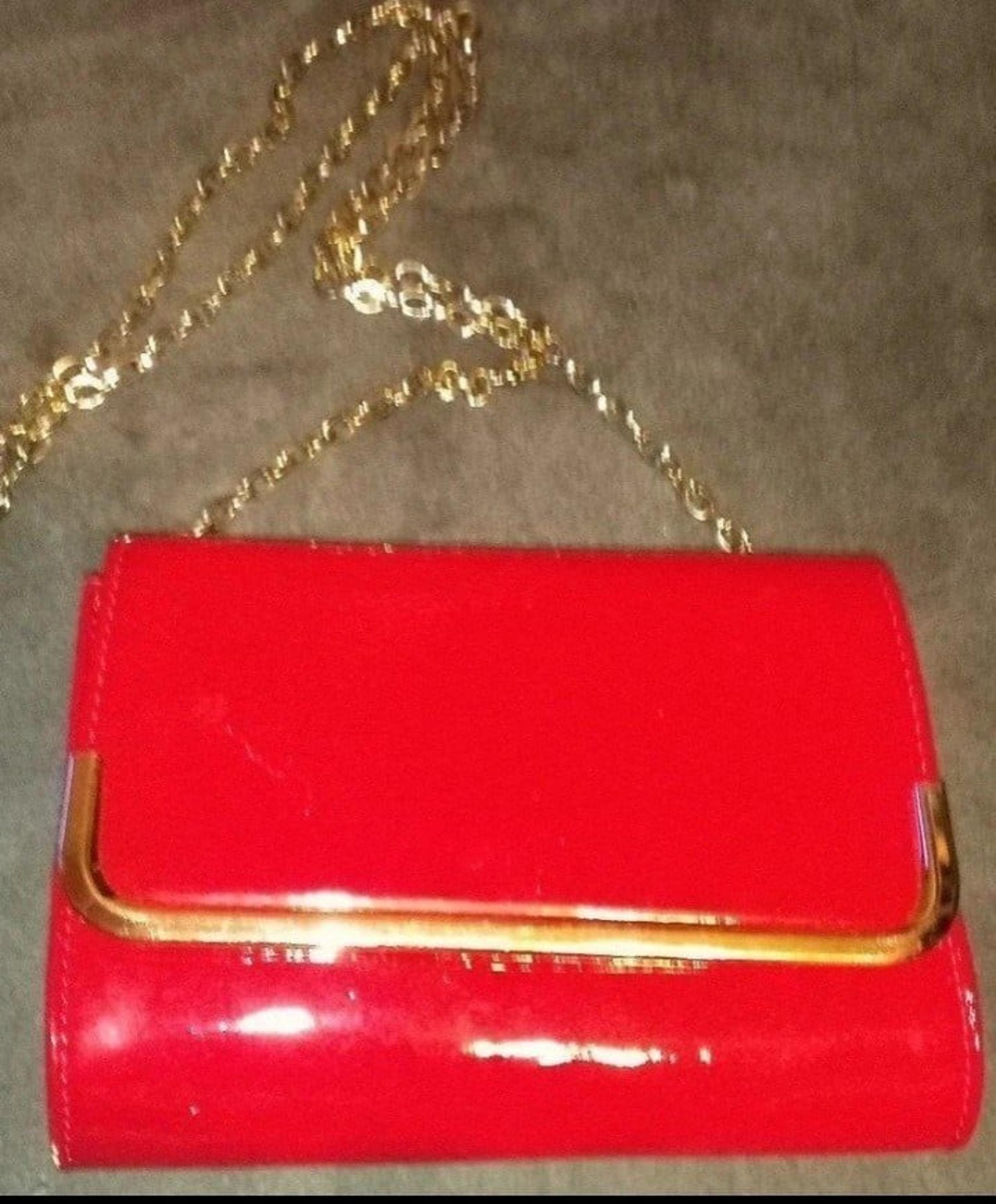 Forever 21 Red clutch purse with gold crossbody chain and gold accent trimming.