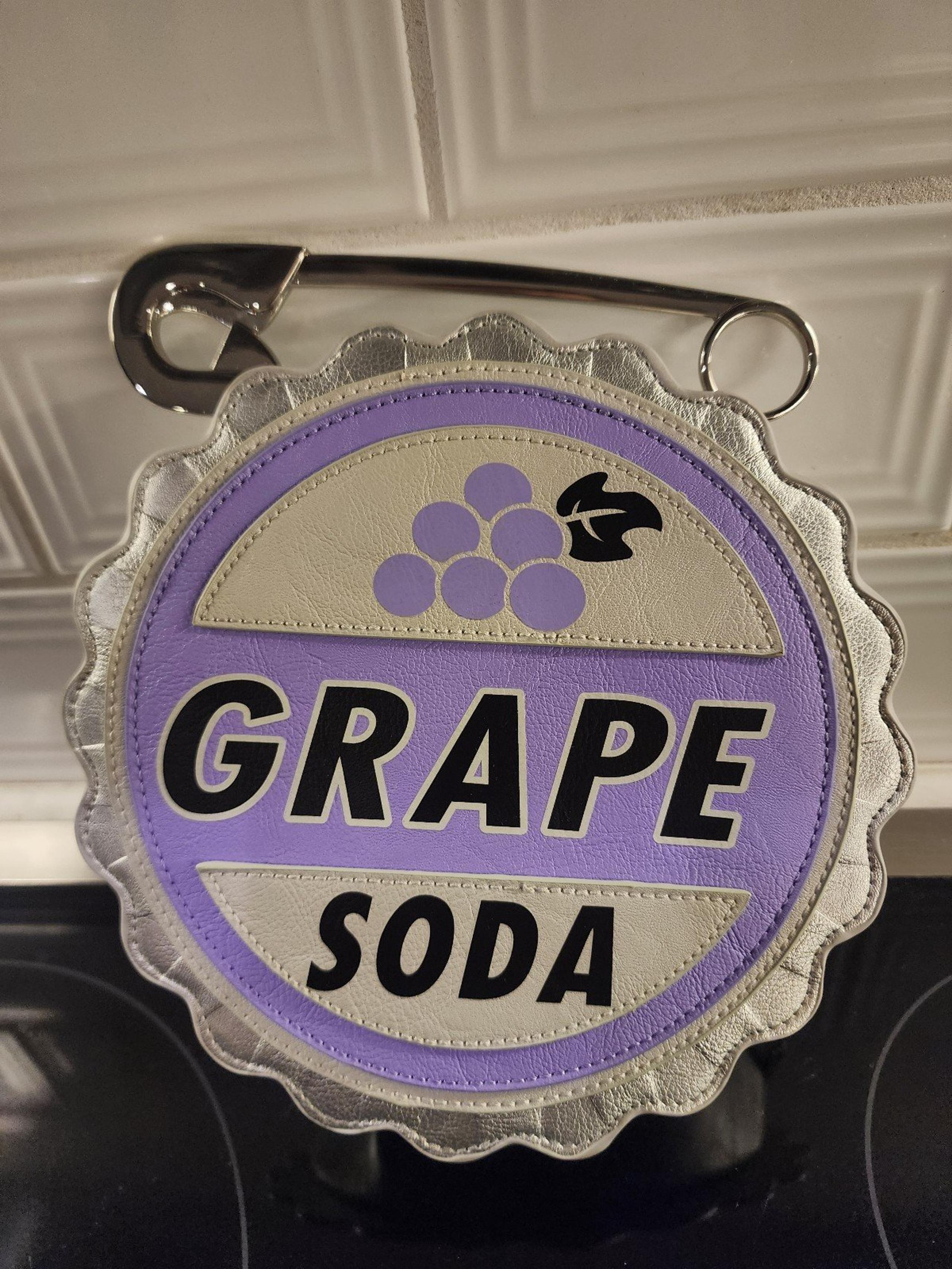Disneys UP Grape Soda Badge Clutch handbag with Safety Pin handle New with Tags