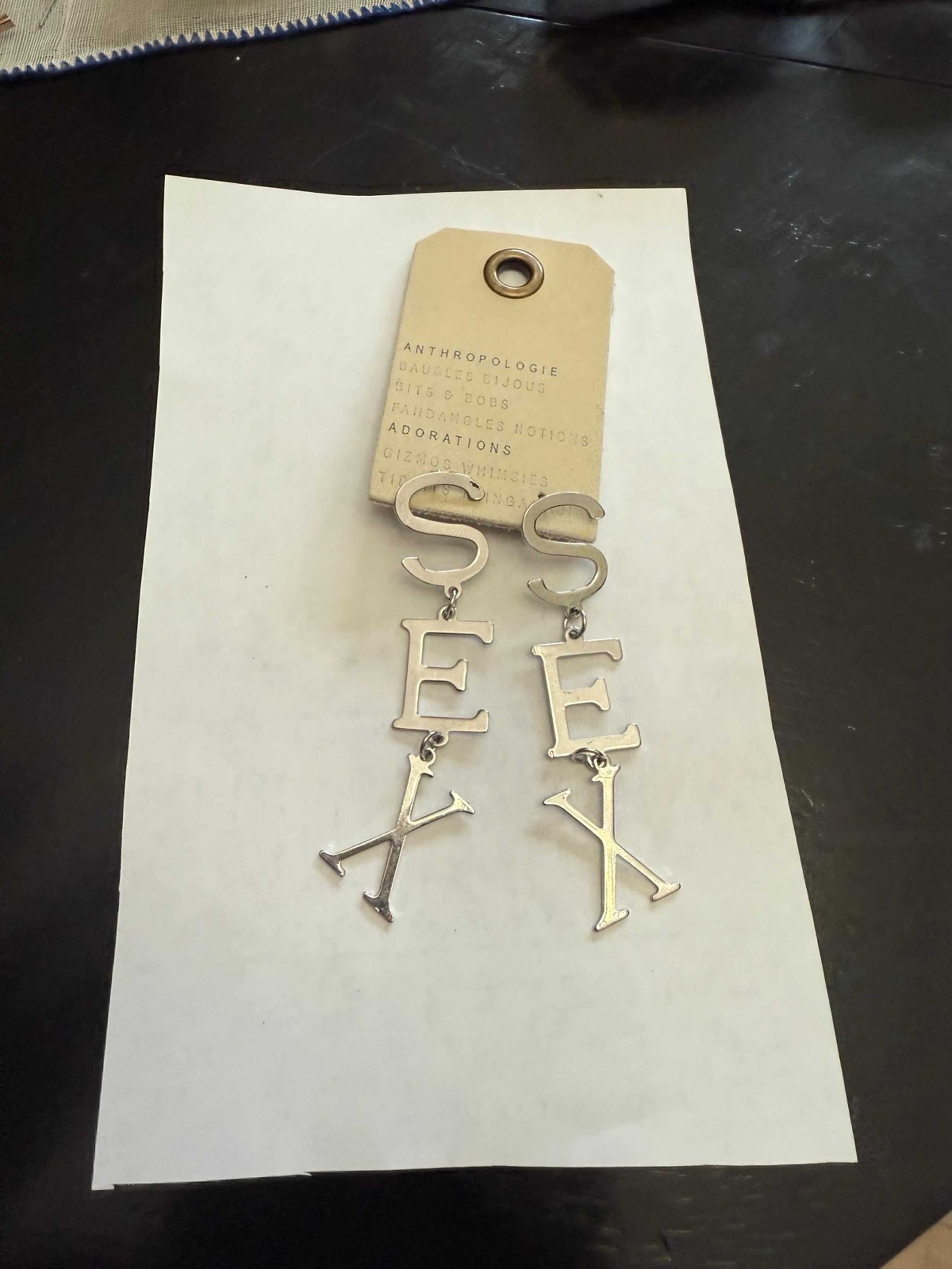 Silver word statement earrings