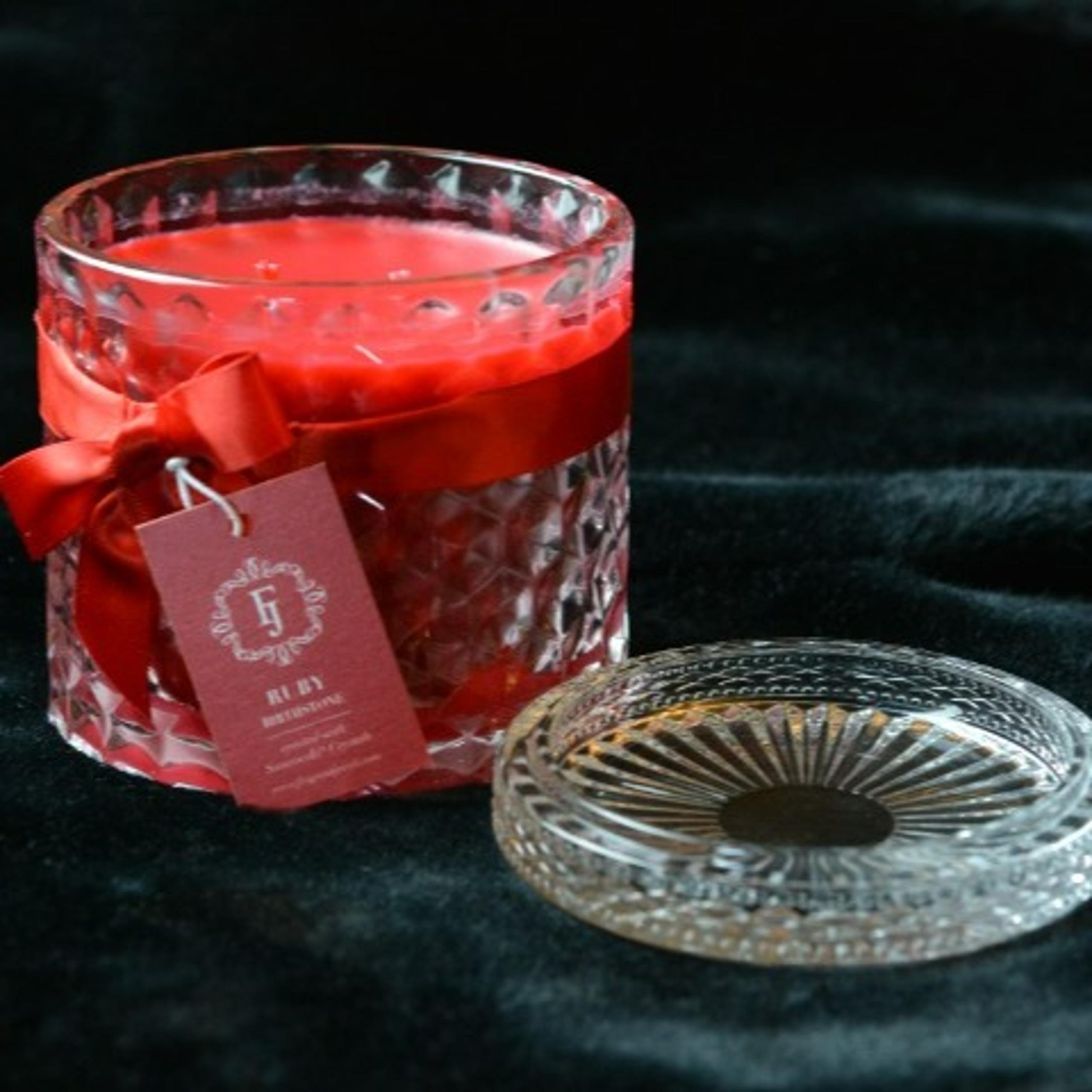 Ringless Satin July candle with clear glass jar and lid.